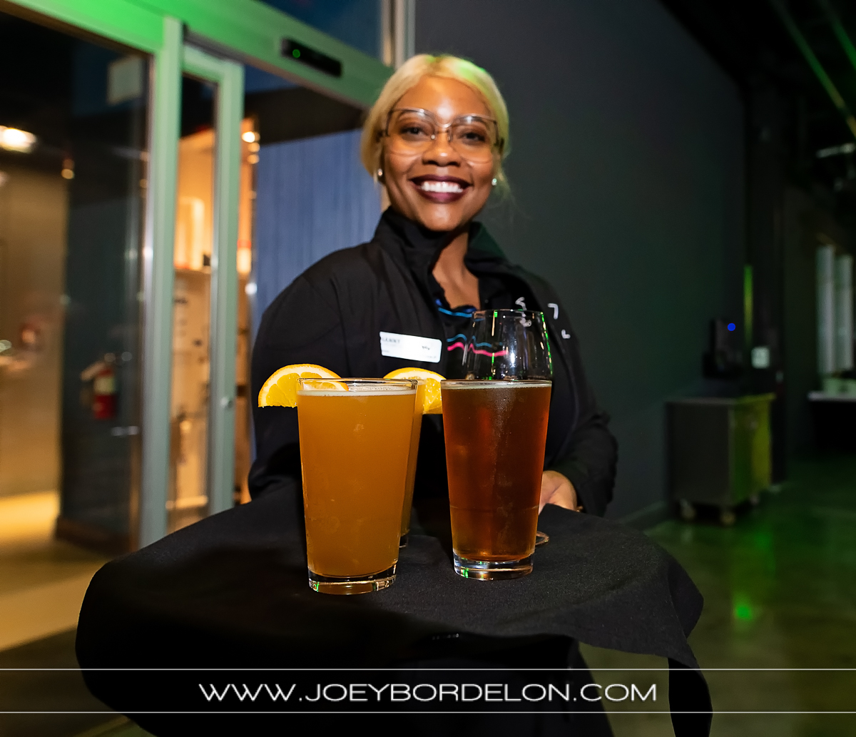 Friendly Top Golf server offering beverages to guests